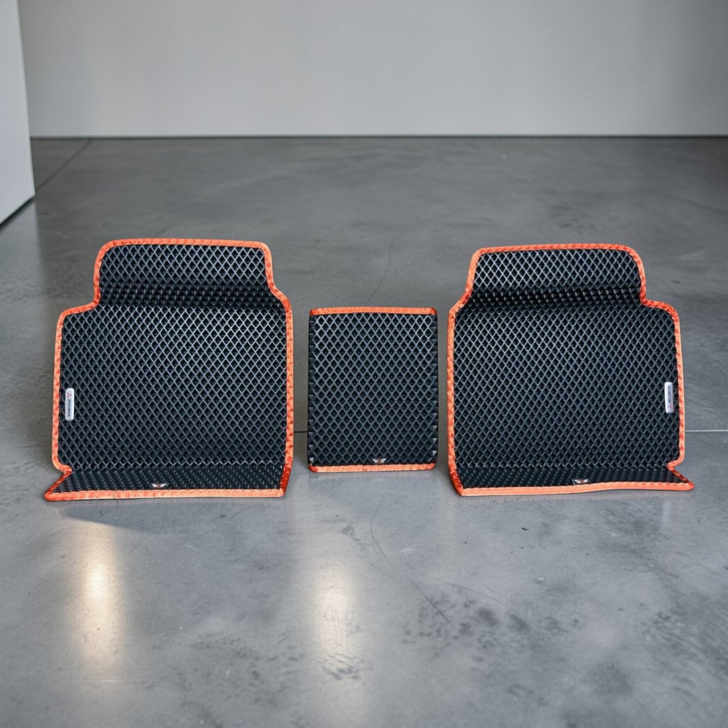 Custom rear EVA car mats with center bridge for Mitsubishi Outlander PHEV 2022–2025, black EVA material with orange trim. Perfect fit for rear floor area, waterproof and easy to clean.
