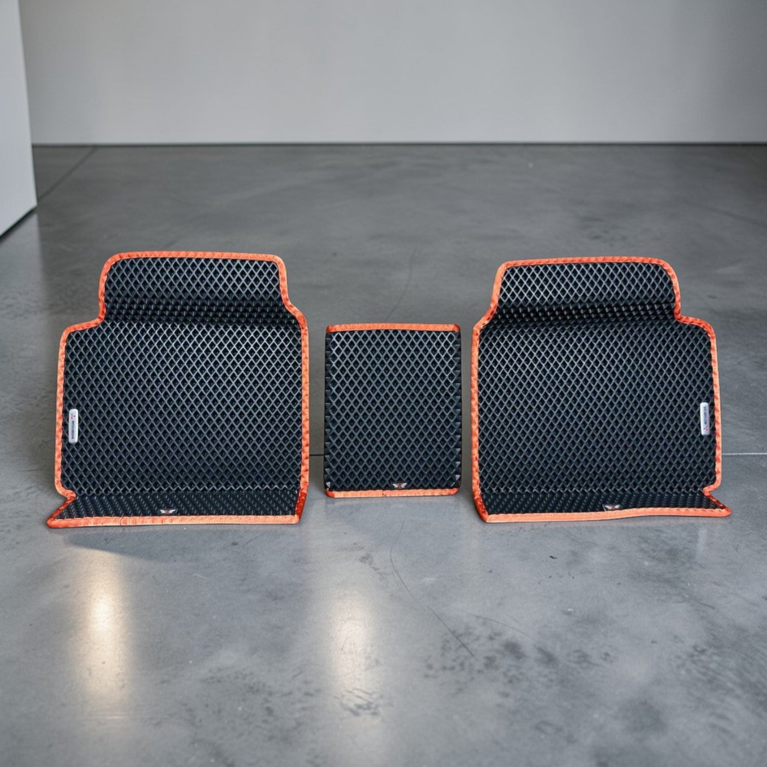 Custom rear EVA car mats with center bridge for Mitsubishi Outlander PHEV 2022–2025, black EVA material with orange trim. Perfect fit for rear floor area, waterproof and easy to clean.